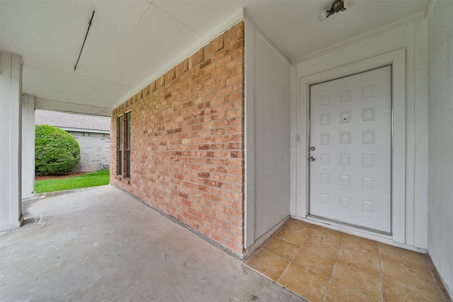 doorway to property with brick siding