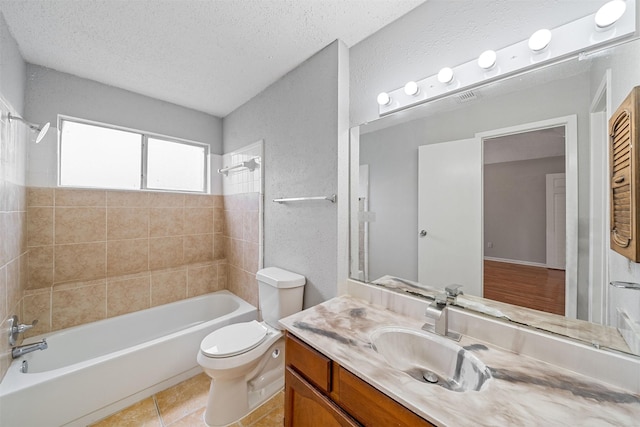 bathroom with a textured ceiling, tile patterned flooring, vanity, toilet, and  shower combination
