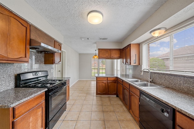 kitchen featuring a textured ceiling, visible vents, range hood, a sink, and black appliances