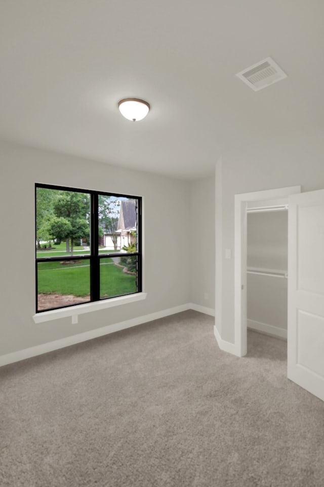 interior space with baseboards, carpet flooring, and visible vents