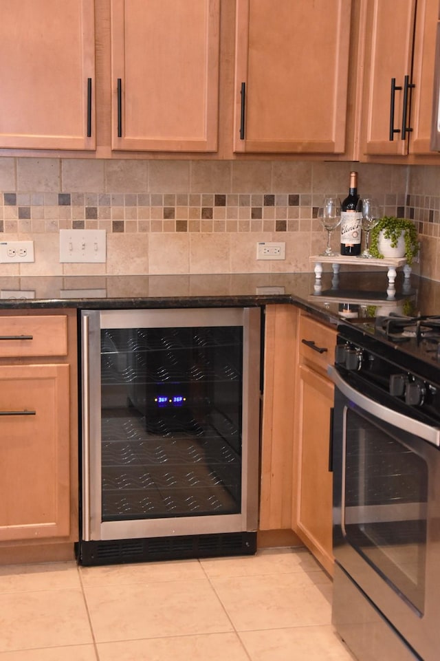 3009 Kurth Canyon Ct, League City, TX 77573 - kitchen with beverage cooler, stainless steel gas range, light tile patterned floors, tasteful backsplash, and dark stone countertops