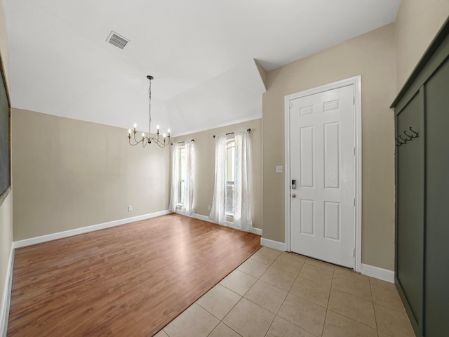 3009 Kurth Canyon Ct, League City, TX 77573 - entryway with a chandelier, lofted ceiling, baseboards, and light wood-style flooring