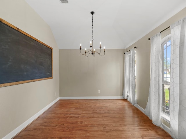 3009 Kurth Canyon Ct, League City, TX 77573 - unfurnished dining area featuring a chandelier, wood finished floors, lofted ceiling, and baseboards