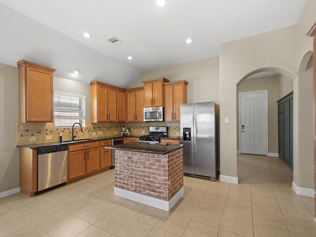 3009 Kurth Canyon Ct, League City, TX 77573 - kitchen with stainless steel appliances, a sink, backsplash, arched walkways, and a kitchen island