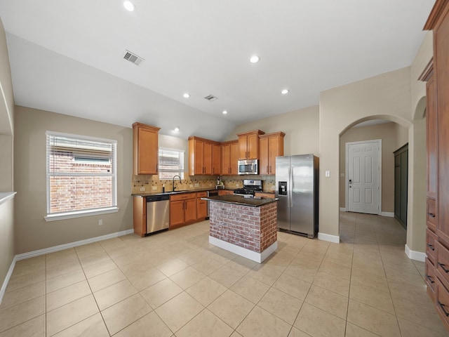 3009 Kurth Canyon Ct, League City, TX 77573 - kitchen featuring stainless steel appliances, dark countertops, backsplash, light tile patterned floors, and vaulted ceiling