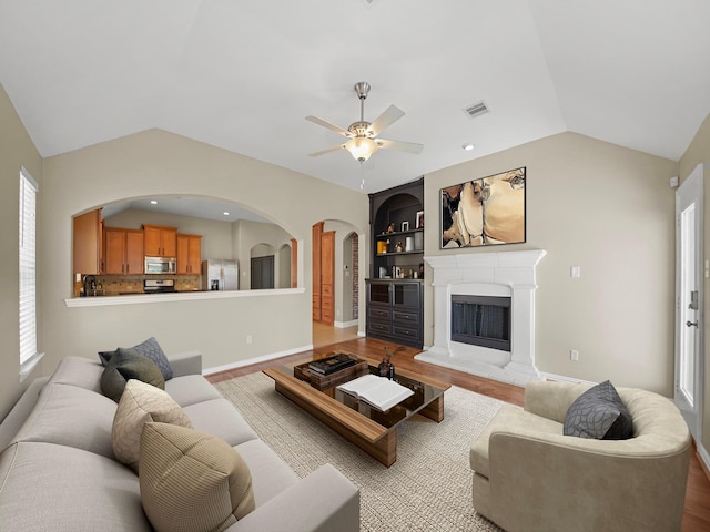 3009 Kurth Canyon Ct, League City, TX 77573 - living area with lofted ceiling, wood finished floors, plenty of natural light, and a ceiling fan