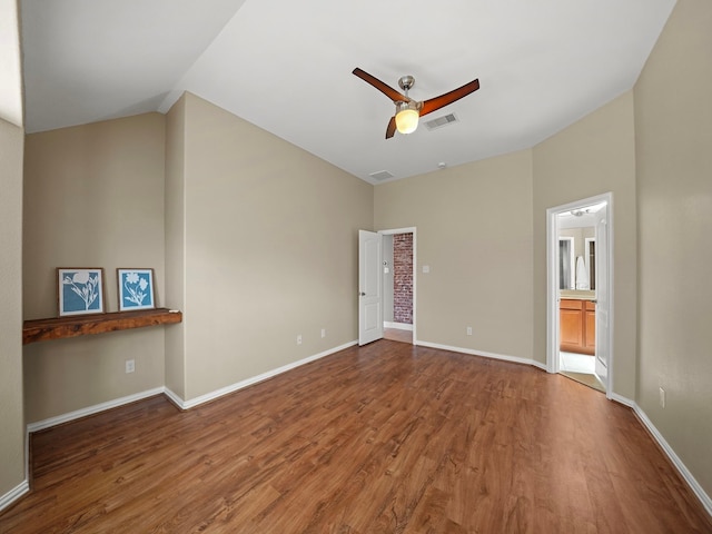 3009 Kurth Canyon Ct, League City, TX 77573 - unfurnished bedroom featuring wood finished floors, lofted ceiling, baseboards, ensuite bathroom, and ceiling fan