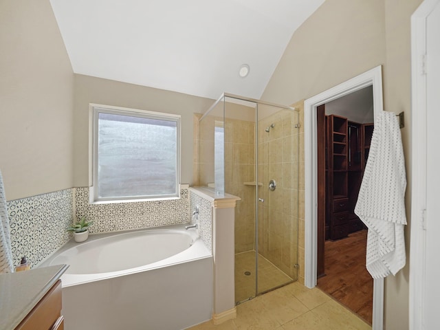 3009 Kurth Canyon Ct, League City, TX 77573 - full bathroom featuring lofted ceiling, a shower stall, tile patterned floors, a bath, and vanity