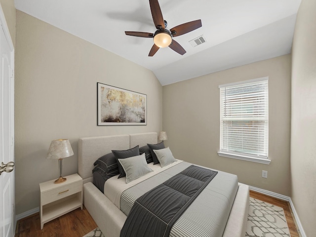 3009 Kurth Canyon Ct, League City, TX 77573 - bedroom with wood finished floors, baseboards, vaulted ceiling, and a ceiling fan