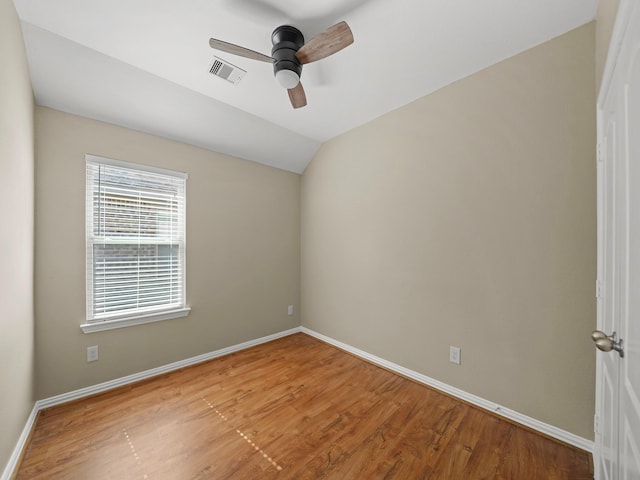 3009 Kurth Canyon Ct, League City, TX 77573 - empty room featuring ceiling fan, wood finished floors, baseboards, and vaulted ceiling