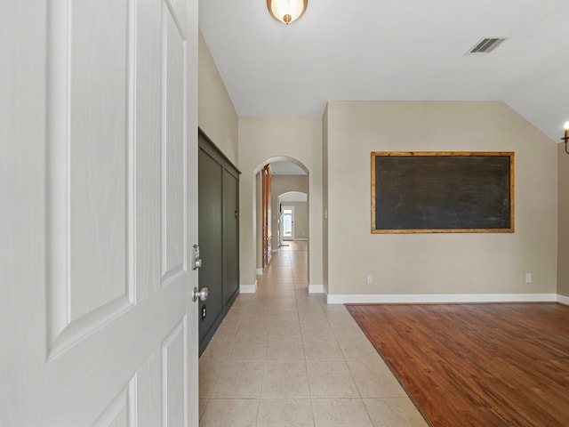 3009 Kurth Canyon Ct, League City, TX 77573 - foyer entrance with arched walkways, light tile patterned floors, baseboards, and vaulted ceiling