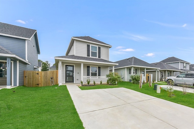 16435 Valerie Marie Pl, Conroe, TX 77306 - view of front of property with covered porch, fence, a shingled roof, and a front lawn