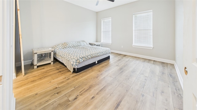 bedroom with baseboards, a ceiling fan, and wood finished floors
