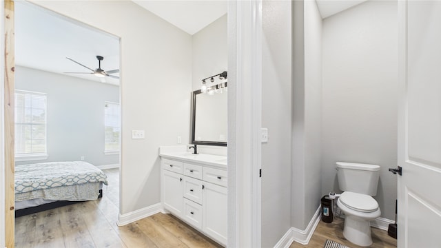 full bathroom with ceiling fan, wood finished floors, vanity, toilet, and connected bathroom