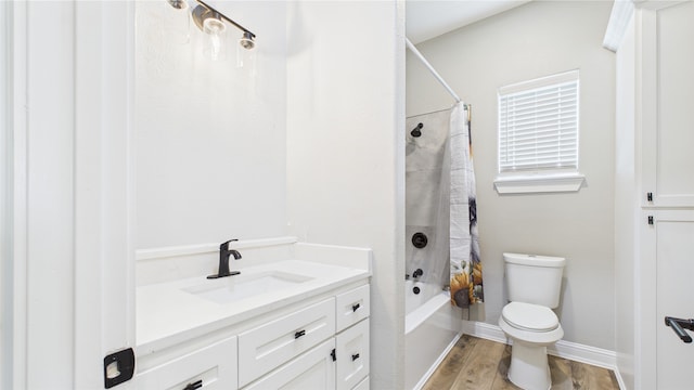 bathroom featuring vanity, toilet, shower / bath combo with shower curtain, baseboards, and wood finished floors