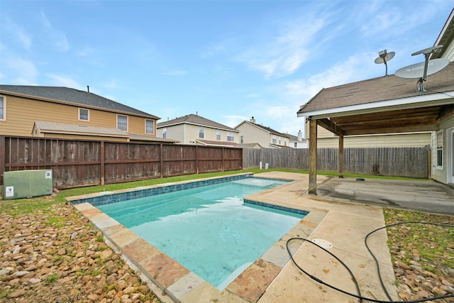 view of pool with a patio, a fenced in pool, a residential view, and a fenced backyard