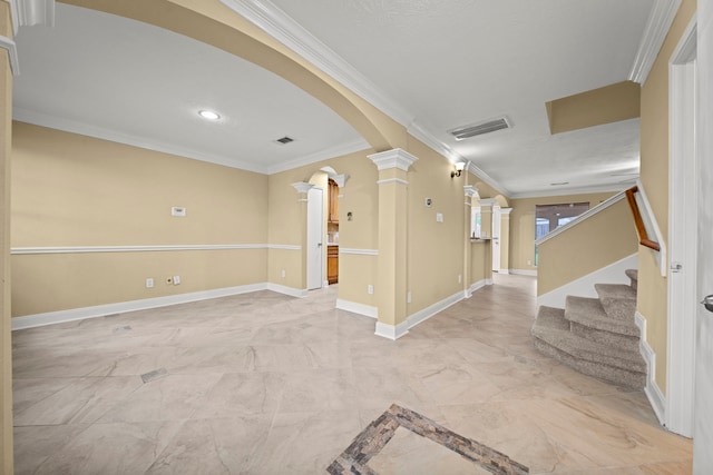 spare room featuring visible vents, ornamental molding, marble finish floor, ornate columns, and arched walkways