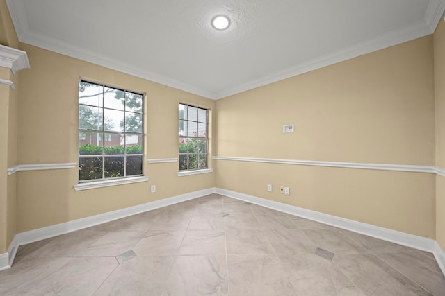 empty room with crown molding and baseboards