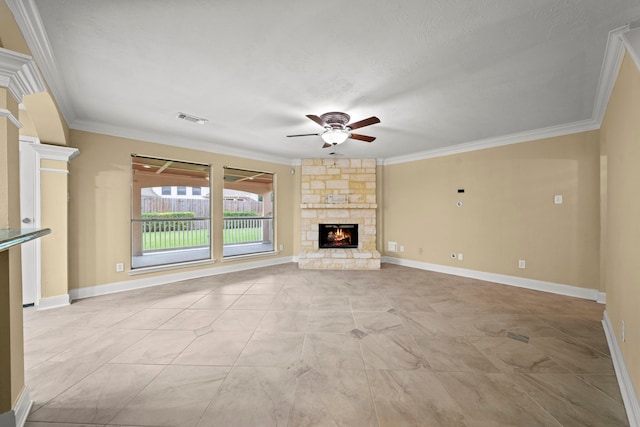 unfurnished living room with visible vents, crown molding, ceiling fan, and a stone fireplace