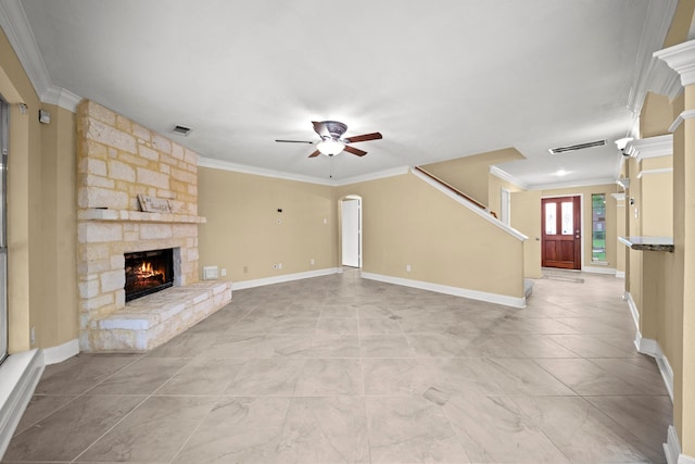 unfurnished living room featuring crown molding, ceiling fan, a fireplace, and visible vents