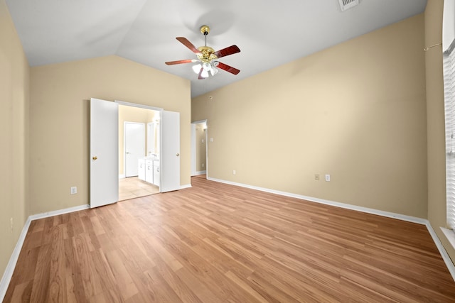 unfurnished bedroom featuring light wood-style floors, baseboards, a ceiling fan, and vaulted ceiling