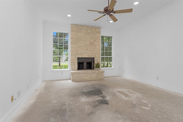 unfurnished living room featuring plenty of natural light, a fireplace, and unfinished concrete floors