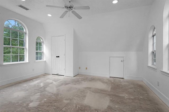 additional living space with visible vents, lofted ceiling, baseboards, ceiling fan, and recessed lighting