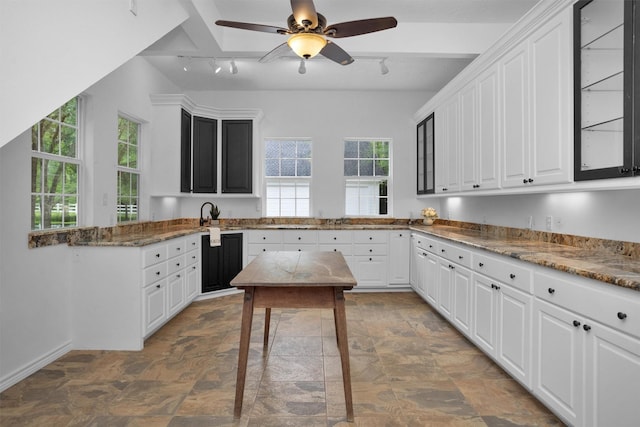 kitchen featuring track lighting, a ceiling fan, white cabinetry, and a healthy amount of sunlight