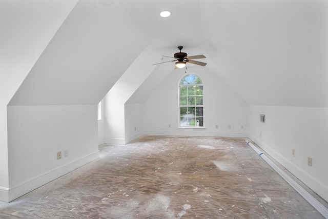 additional living space with visible vents, baseboards, ceiling fan, and vaulted ceiling