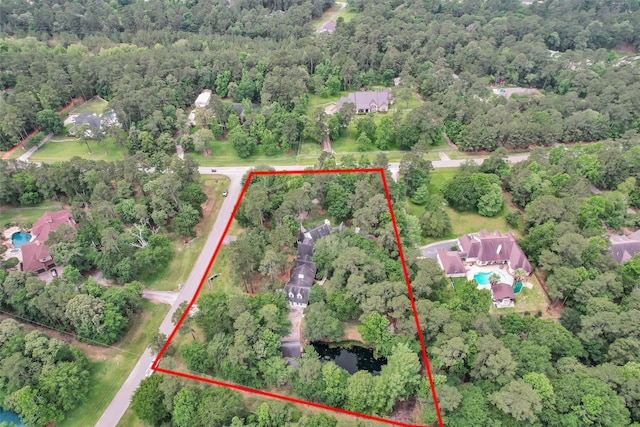 birds eye view of property with a wooded view