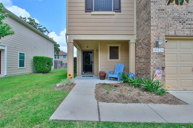 doorway to property featuring a yard and a garage