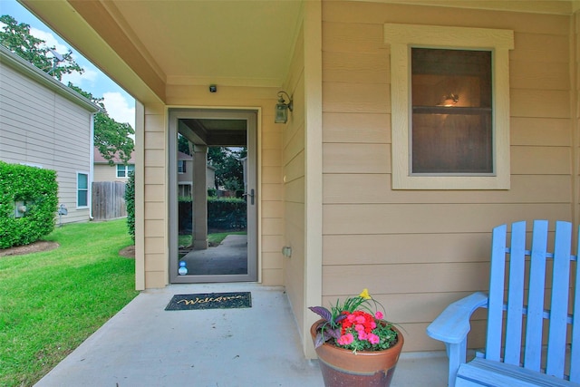doorway to property featuring a yard