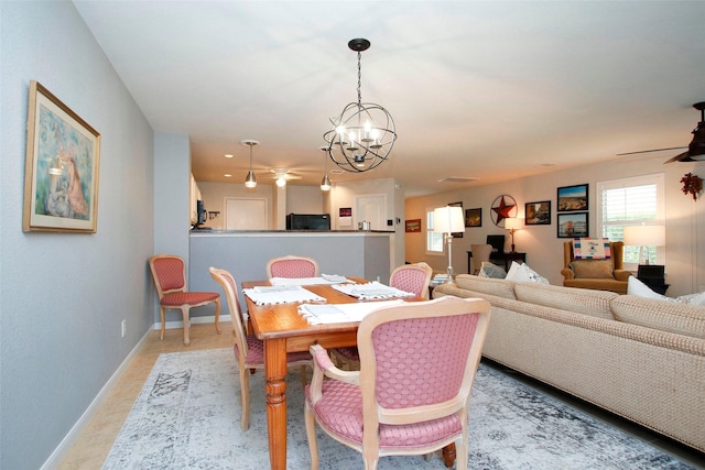 dining space with an inviting chandelier, baseboards, and light tile patterned floors