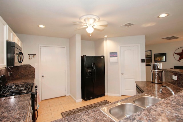 kitchen with ceiling fan, dark countertops, a sink, visible vents, and black appliances