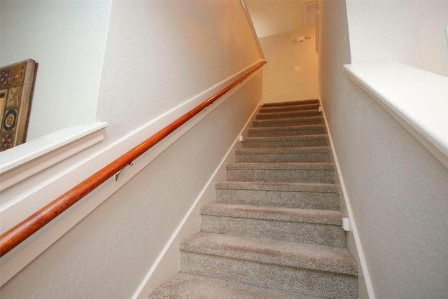 stairway with a textured wall