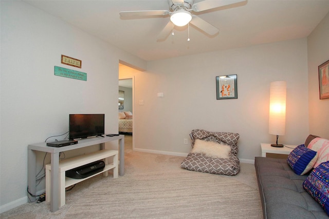 living room with baseboards, ceiling fan, and carpet flooring