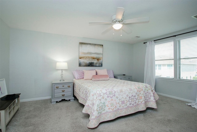 carpeted bedroom with a ceiling fan, baseboards, and visible vents