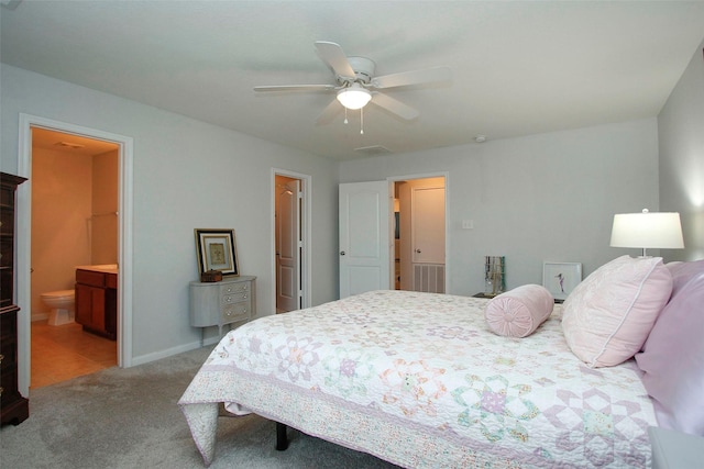bedroom featuring ceiling fan, carpet, baseboards, ensuite bathroom, and visible vents