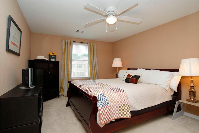 bedroom featuring visible vents, ceiling fan, and light colored carpet