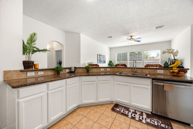 kitchen with ceiling fan, white cabinetry, light tile patterned floors, a sink, and dishwasher