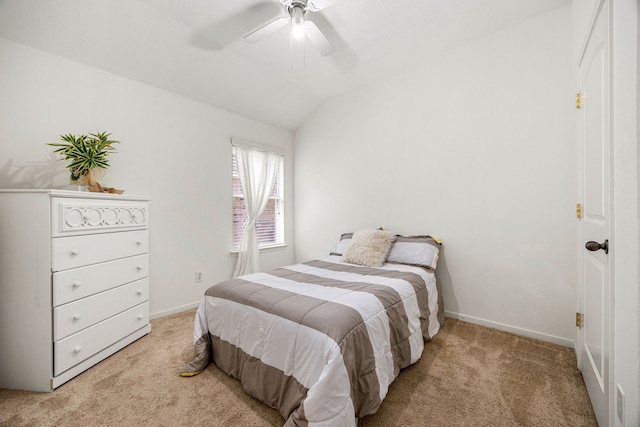 bedroom featuring baseboards, ceiling fan, vaulted ceiling, and light colored carpet