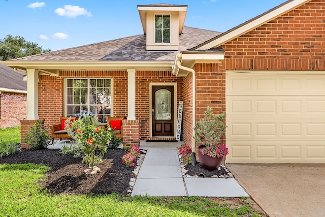 doorway to property with brick siding, a shingled roof, and a garage