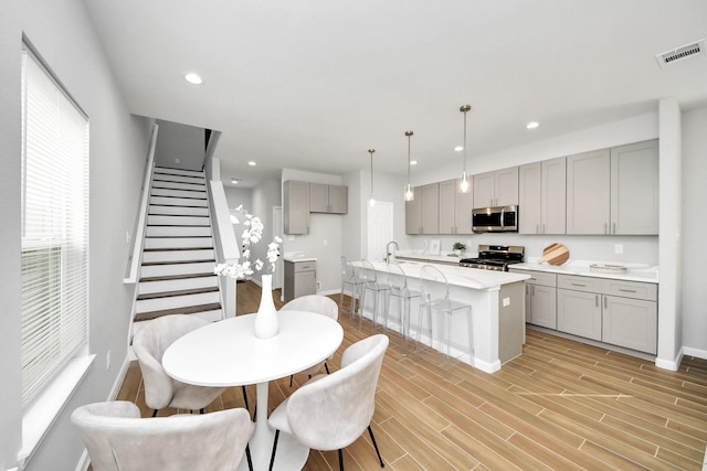 326 Gans St Unit A, Houston, TX 77029 - kitchen with visible vents, baseboards, gray cabinetry, and stainless steel appliances