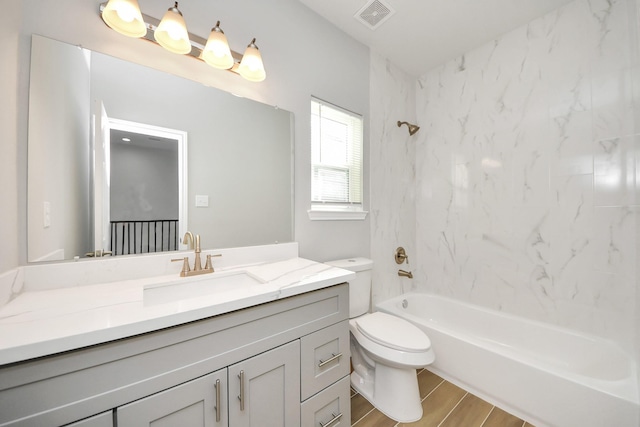 326 Gans St Unit A, Houston, TX 77029 - bathroom featuring vanity, toilet, bathing tub / shower combination, wood finished floors, and visible vents