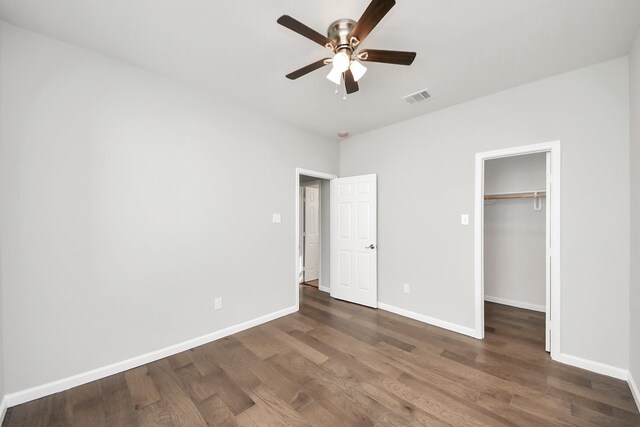 326 Gans St Unit A, Houston, TX 77029 - unfurnished bedroom featuring visible vents, wood finished floors, baseboards, a walk in closet, and ceiling fan