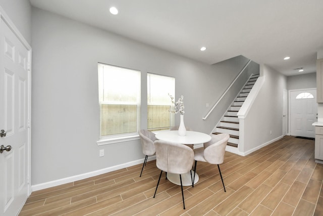 326 Gans St Unit A, Houston, TX 77029 - dining area with baseboards, light wood finished floors, and stairway