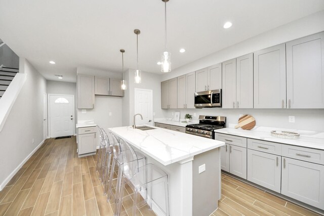 326 Gans St Unit A, Houston, TX 77029 - kitchen featuring a sink, gray cabinets, wood finish floors, and stainless steel appliances