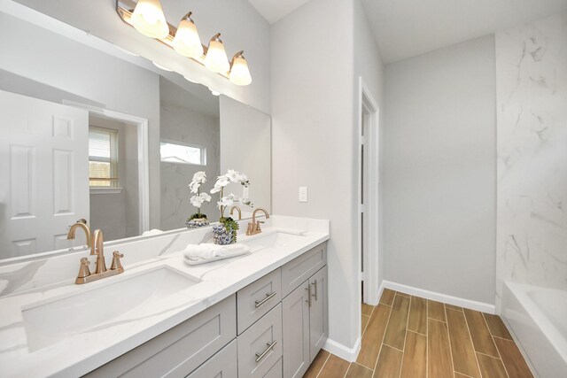 326 Gans St Unit A, Houston, TX 77029 - full bath with a sink, a tub, wood finish floors, and double vanity