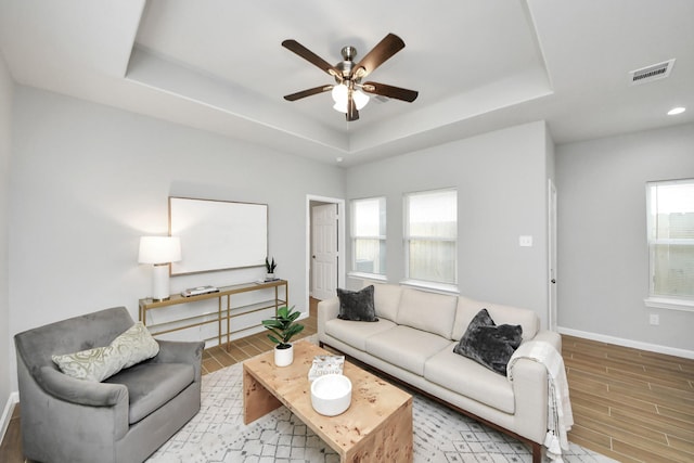 326 Gans St Unit A, Houston, TX 77029 - living area with visible vents, baseboards, wood finish floors, a raised ceiling, and a ceiling fan