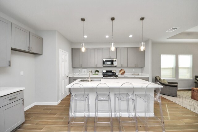 326 Gans St Unit A, Houston, TX 77029 - kitchen featuring visible vents, gray cabinetry, baseboards, stainless steel appliances, and recessed lighting